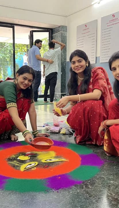 Students making a rangoli